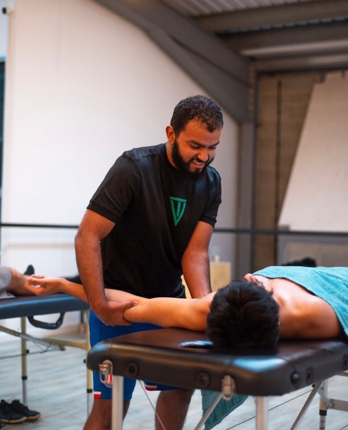 Assisted stretching — working on a client's shoulder
